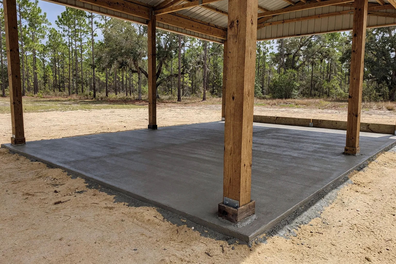 Concrete slab poured inside existing pole barn posts near Lakeland, Polk County