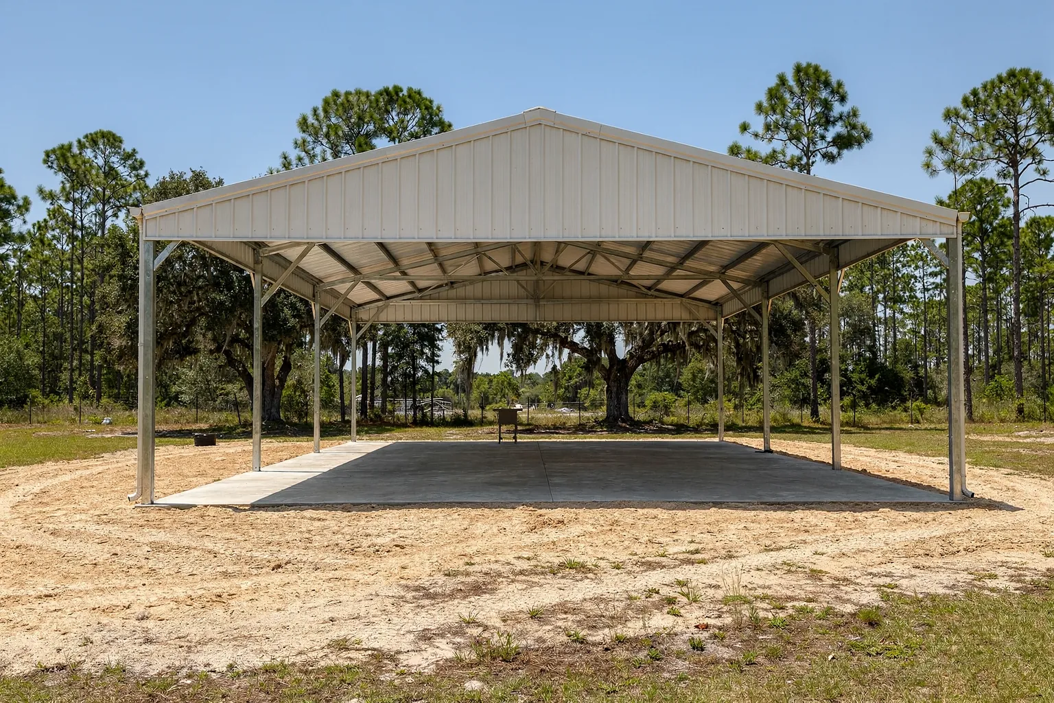 Finished concrete pole barn slab under an open post-frame barn near Bartow, Polk County